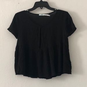 Short, black peplum top with eyelet cut out